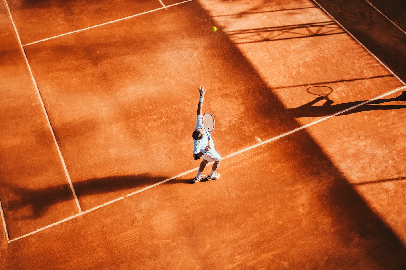 Player training on a clay tennis court